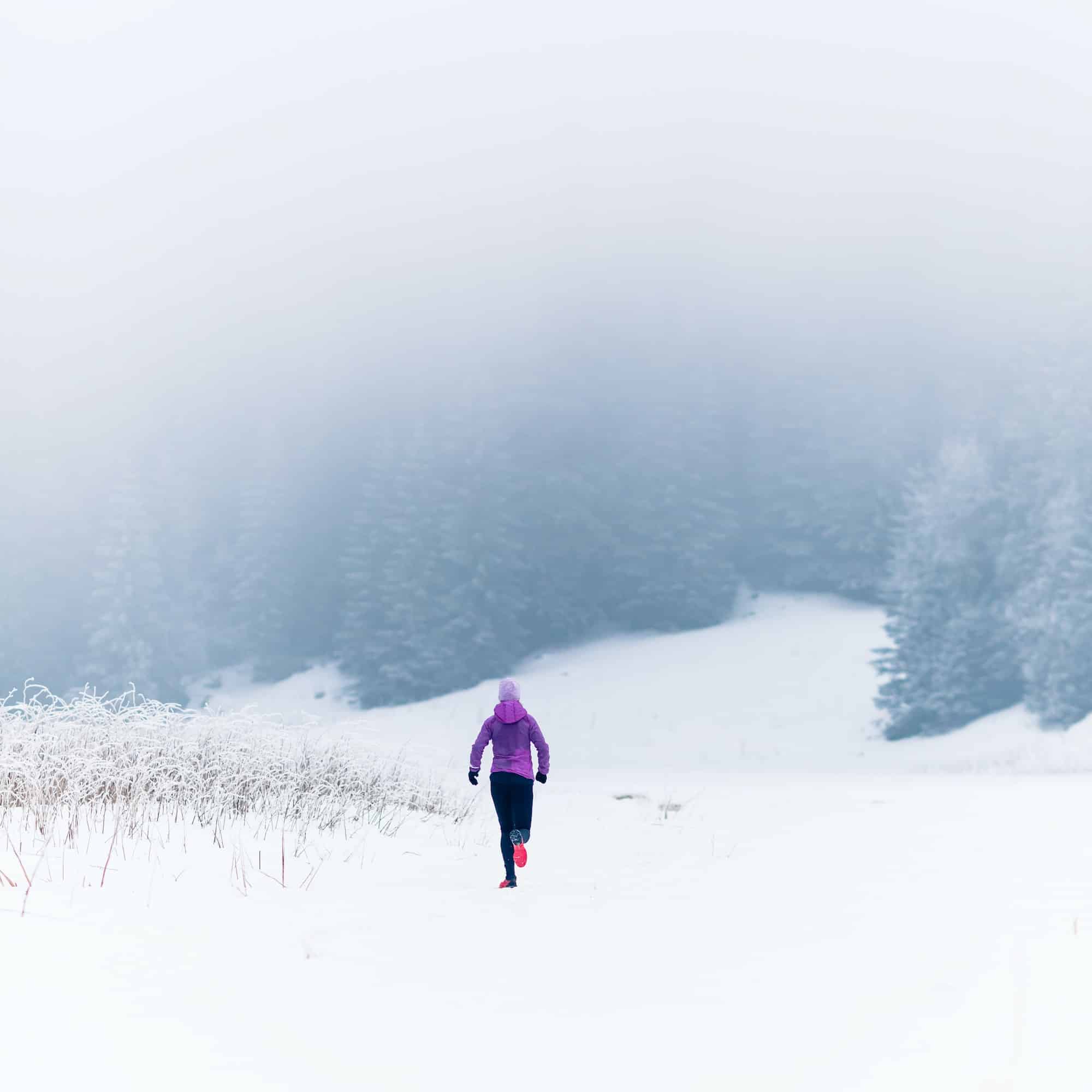 Woman running on winter trail, fitness inspiration and motivatio
